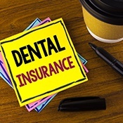Dental insurance written on yellow note paper