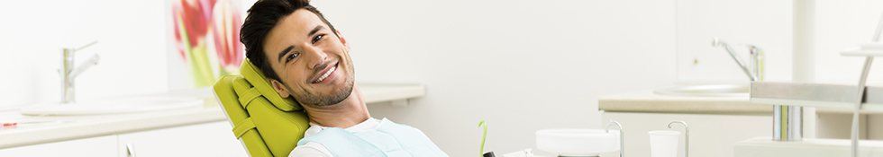 Young man smiling in dental chair