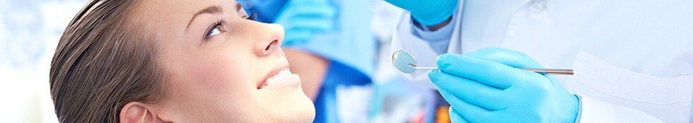 Dentist checking woman's smile