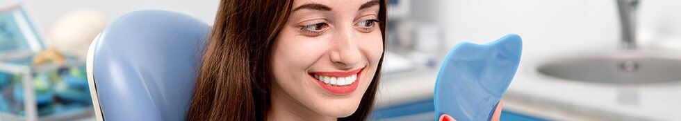 Woman checking smile in mirror