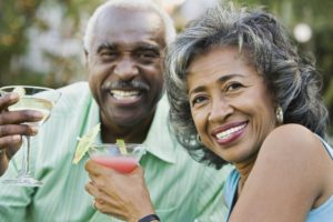 Mature couple enjoying drinks. 